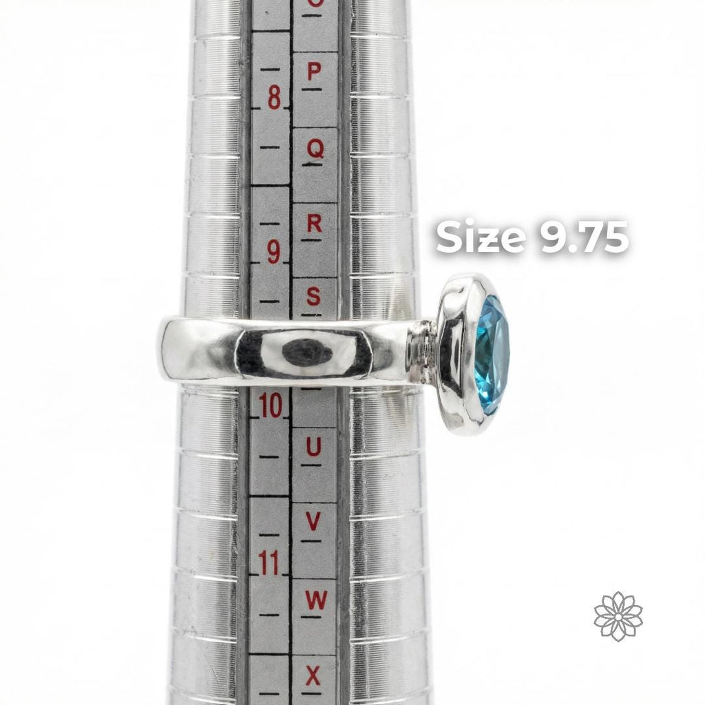 Side view of a sterling silver sapphire ring on a ring mandrel showing band thickness, bezel height, and scale