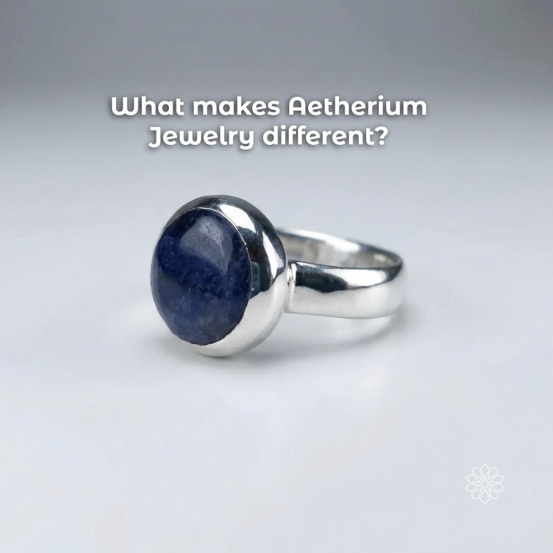 Angled view of a sterling silver bezel-set blue sapphire cabochon ring highlighting the domed stone surface and handmade finish. Text reads “What makes Aetherium Jewelry different?”