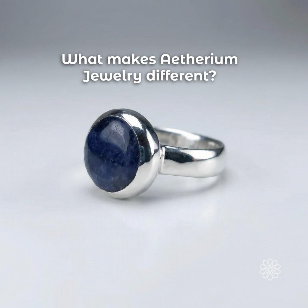 Angled view of a sterling silver bezel-set blue sapphire cabochon ring highlighting the domed stone surface and handmade