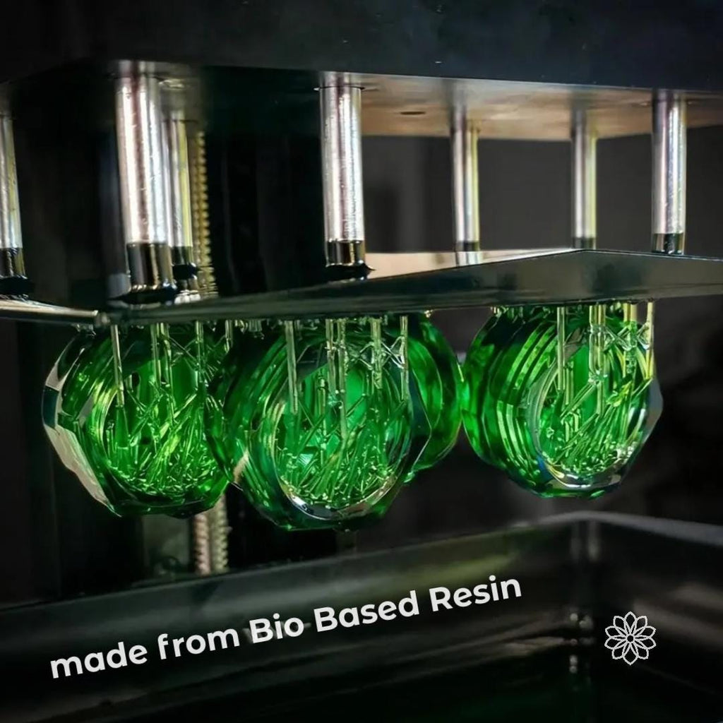 Ultralight backcountry bidet cap made from bio-based resin, showing translucent green material and precision construction. Sustainable bottle rinse nozzle designed for backpacking hygiene, combining lightweight durability with reduced environmental impact for outdoor use, camping, and ultralight travel systems.