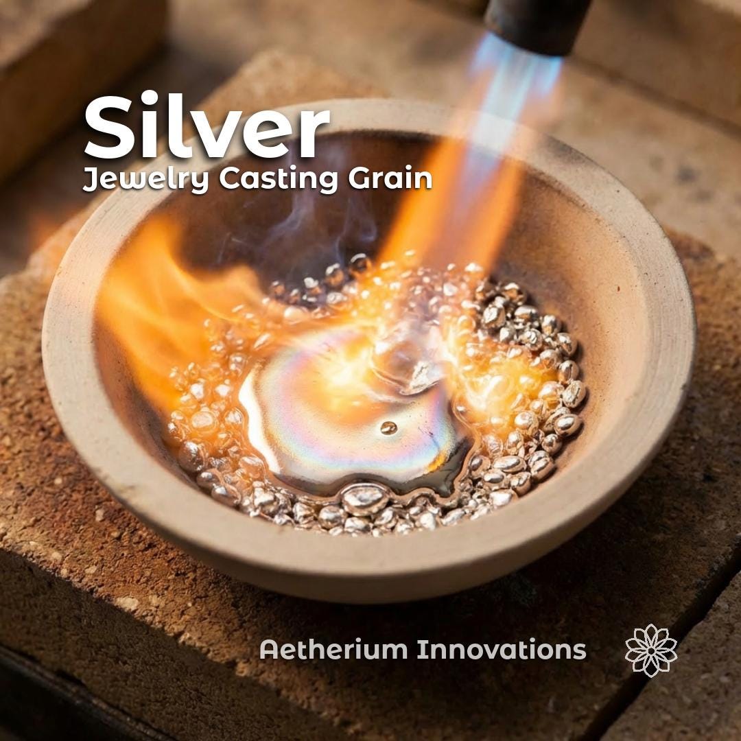 silver jewelry casting grain melting in a ceramic crucible under a torch flame, bright orange heat surrounding liquid silver pool with solid beads around the edge, text overlay reads “Silver Jewelry Casting Grain” and “Aetherium Innovations,” showing real casting process and metal behavior