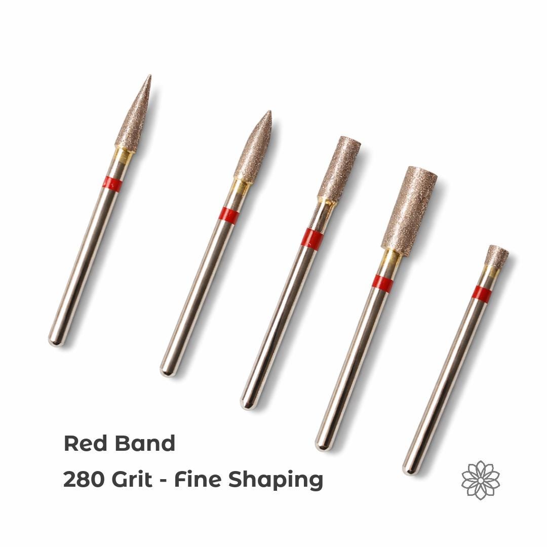 Set of sintered diamond burrs with red bands indicating 280 grit, displayed in multiple shapes designed for controlled material removal, shaping, and initial surface work on stone, glass, and metal.