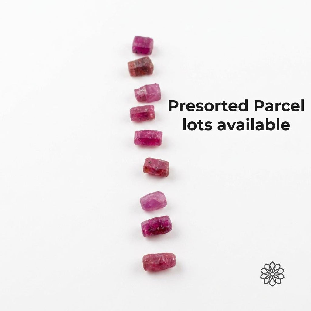 Presorted pink Madagascar ruby and sapphire rough pieces arranged vertically on a white background with text reading “Presorted Parcel lots available.” The image communicates curated natural corundum parcels with visible color range, inclusion character, and rough crystal form for lapidary artists choosing material by project needs.