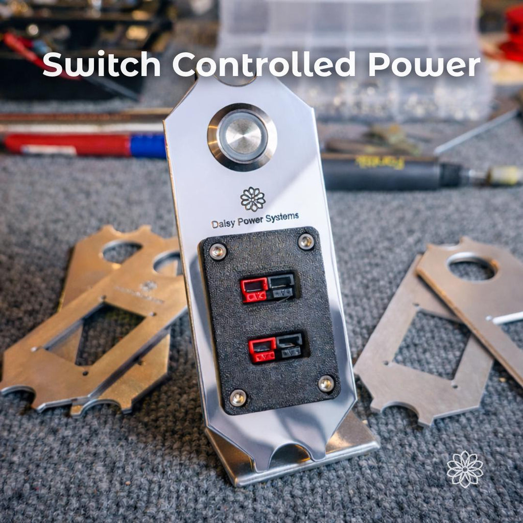 Text reads “Switch Controlled Power.” Daisy Power Systems aluminum DC panel shown on a workshop surface with two round push switches and two Anderson Powerpole output pairs. This image shows the panel’s main function: giving Super Pacific X1 owners switch-controlled DC power for camper accessories, lighting, fans, fridge wiring, or auxiliary gear.