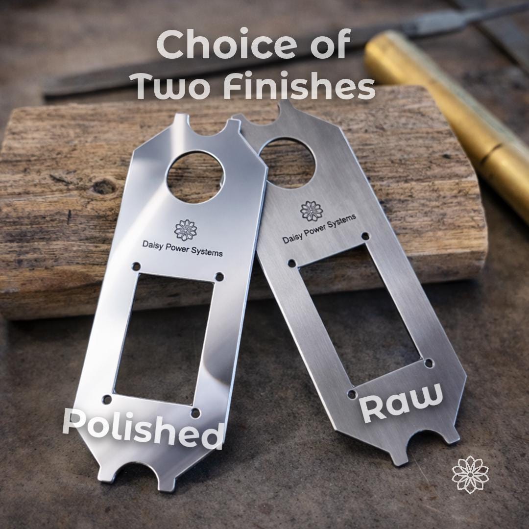 Text reads “Choice of Two Finishes,” with labels “Polished” and “Raw.” Two aluminum Daisy Power Systems faceplates are shown side by side on a wood block. The polished option has a brighter reflective surface, while the raw option has a brushed machined look for a more utilitarian Super Pacific X1 camper interior.