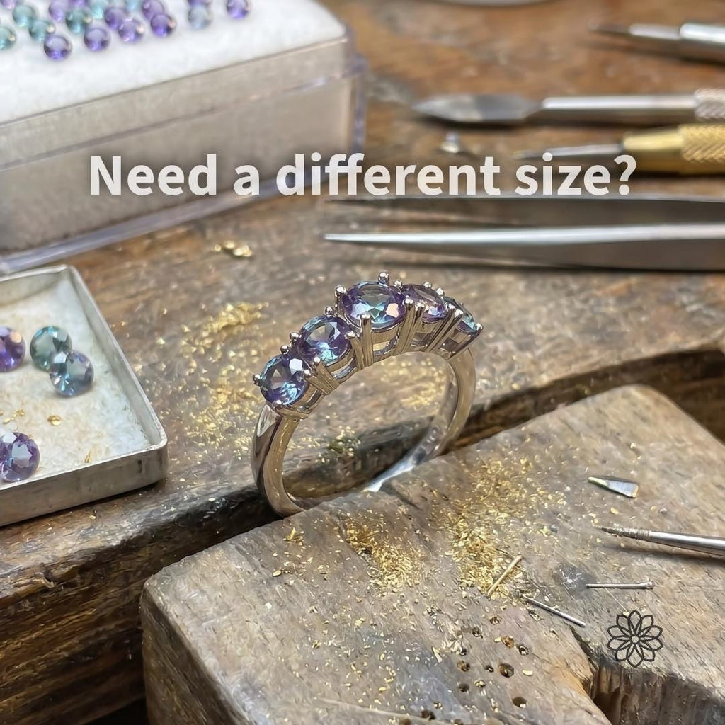 Finished alexandrite ring on a jeweler’s bench with loose stones, tweezers, gravers, and gold filings nearby. Text reads “Need a different size?” showing how calibrated alexandrite stones support custom rings, matched layouts, larger accents, and professional jewelry builds beyond the listed 2mm melee size.