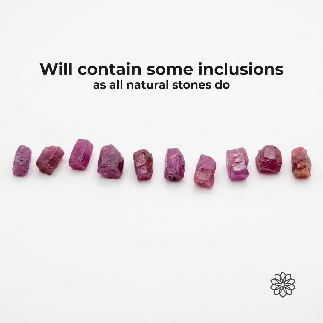 Line of natural pink Madagascar ruby and sapphire rough pieces on a white background with text reading “Will contain some inclusions as all natural stones do.” The image clearly shows color variation, surface texture, mineral inclusions, and natural rough character for lapidary artists seeking honest corundum material.