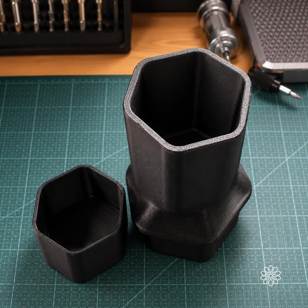 Jeep Nalgene cup holder adapter shown with removable lower insert beside the main carbon fiber polymer body, highlighting the two-piece design, hollow storage area, and large bottle support.