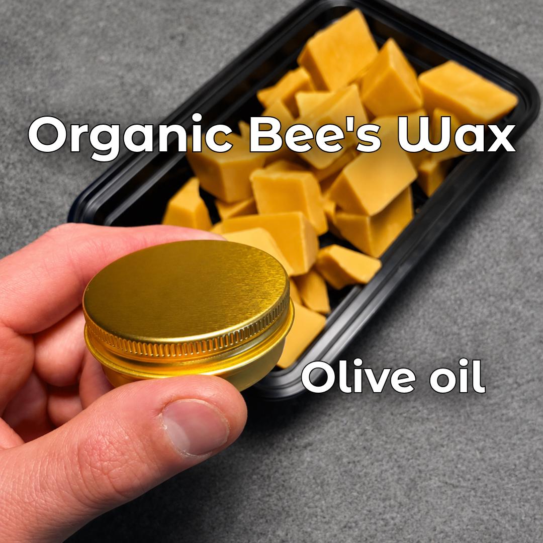 Organic beeswax pieces, olive oil, and a gold salve tin shown as simple natural ingredients for small-batch Pine & Cedar Rockhounder’s Salve.