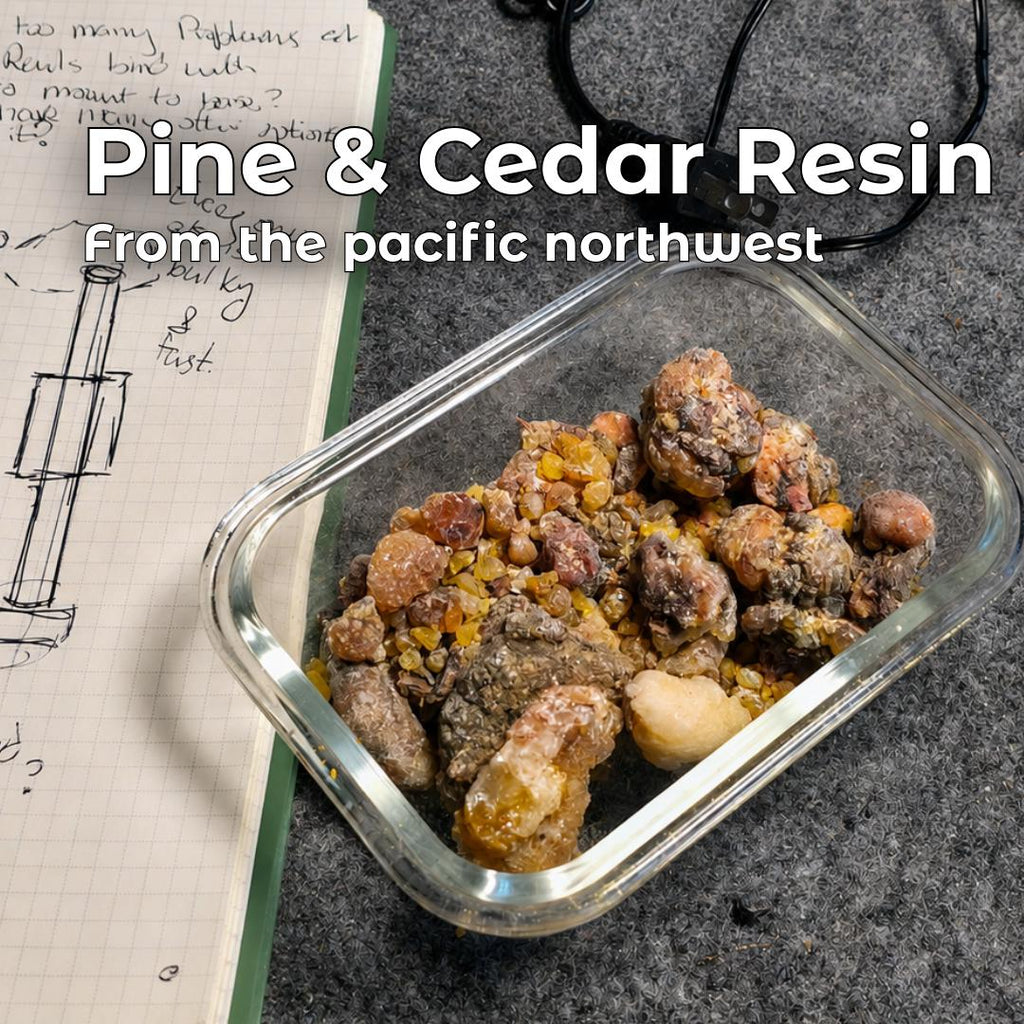 Raw pine and cedar resin collected in the Pacific Northwest, shown in a glass container on a workshop bench beside handwritten design notes. This forest-foraged resin is cleaned, filtered, and blended into Aetherium Rockhounder’s Salve, a small-batch hand balm made with simple natural ingredients.