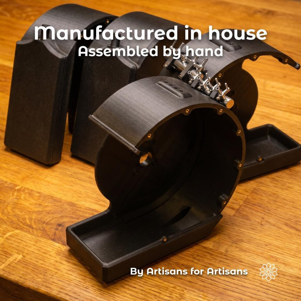 Black wet grinder housings for the Cut n’ Cab V2 MakerSpace Edition shown on a wood bench with hardware installed, highlighting in-house manufacturing, hand assembly, and artisan-built parts for a modular maker workstation.