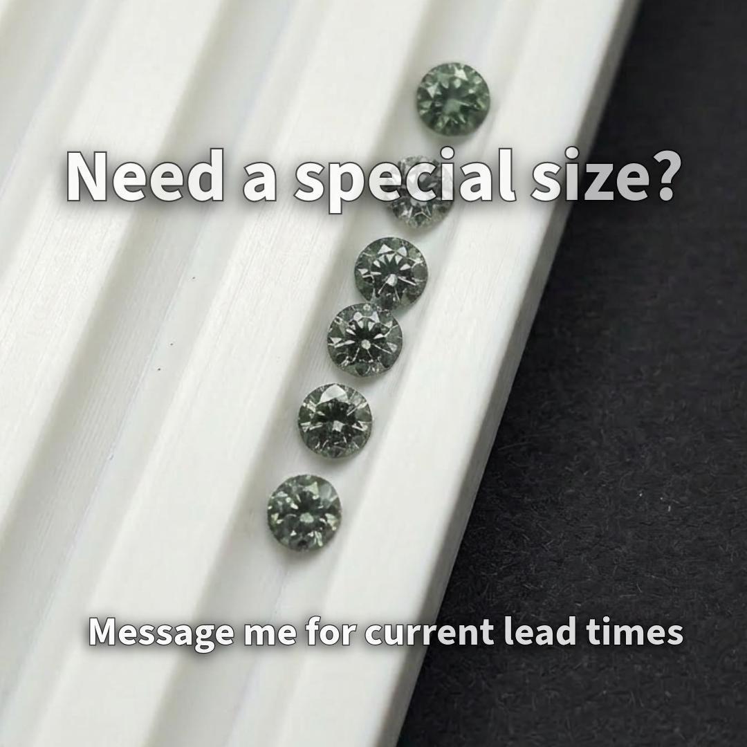 Close-up image of 2 mm lab-grown green tourmaline stones with one held in tweezers next to a fingertip for scale. The gemstones display deep green color, consistent round cuts, and clean facets. This image highlights size accuracy and suitability for precision jewelry work including halo settings, side stones, and detailed micro placement.