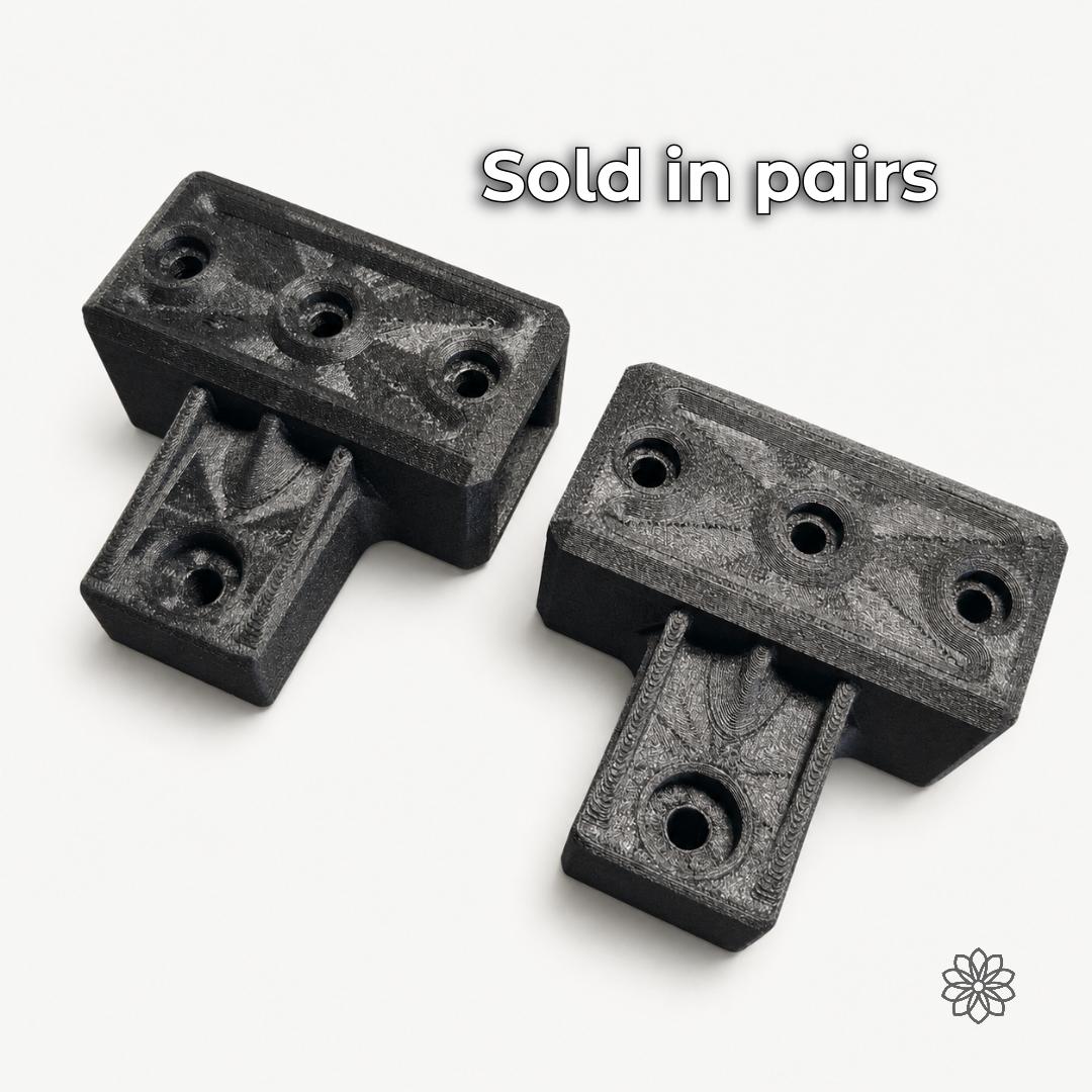 Pair of 2020 mounting brackets with recessed holes shown on a light background.