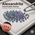 Czochralski alexandrite on an ivory white gem mat, a finger comparison showing the tiny stones and their color shifting properties under changing lighting conditions.