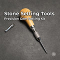 Wooden-handled stone setting tool with knurled chuck, pointed setting tip, and loose adapter collet on a white work surface