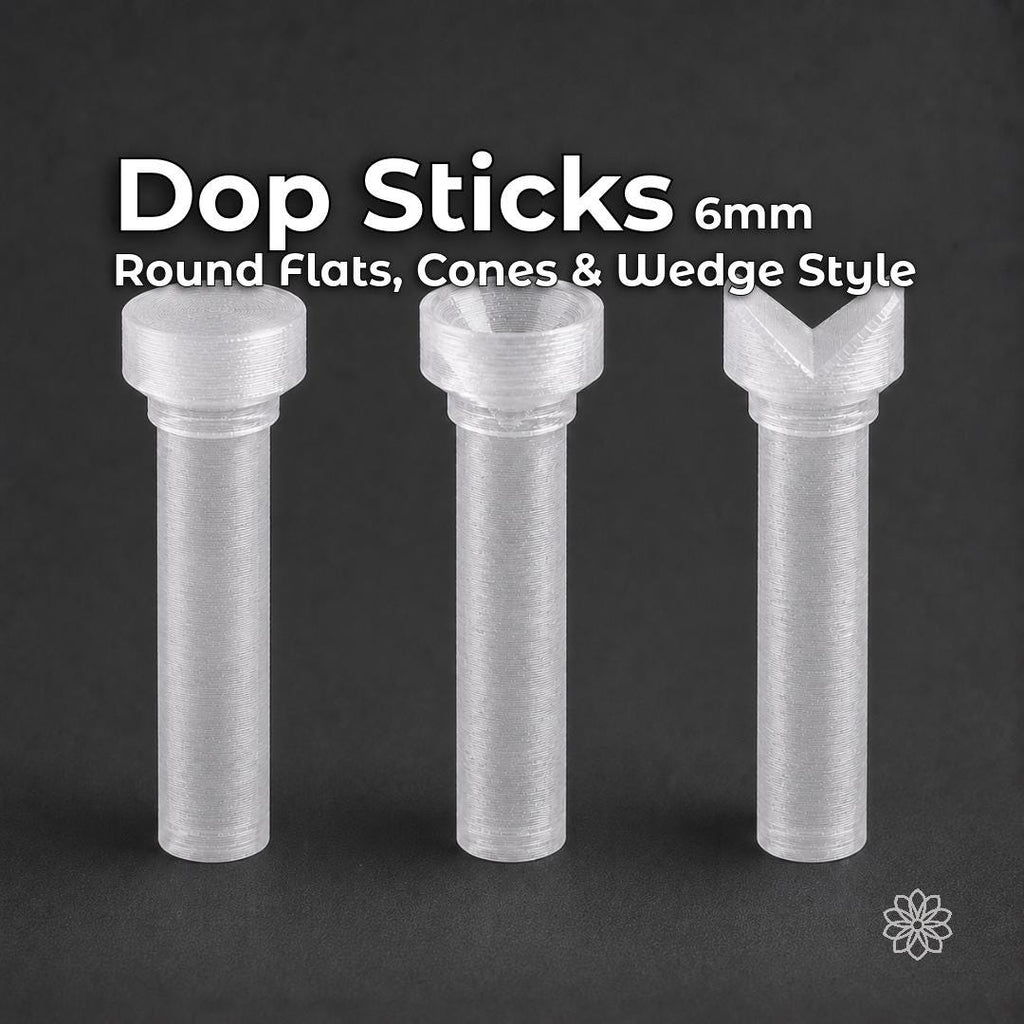 Three transparent polycarbonate lapidary dop sticks standing on a dark background, showing flat round, recessed cone and V-shaped wedge profiles. Each dop has a 6 mm shaft and is designed for epoxy or CA gemstone dopping in compatible faceting equipment.