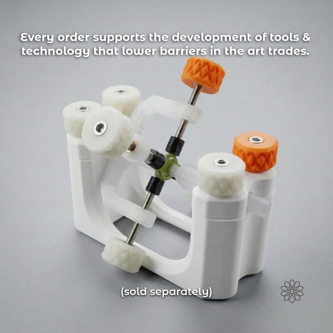 White Aetherium gemstone transfer and alignment fixture holding a green stone between opposing dop shafts, with orange and white adjustment knobs. The accessory is sold separately and forms part of the Aetherium lapidary ecosystem for adhesive dopping, transfer and alignment.