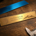 a cnc machined motif on a 2x8 brass plaque. engraving features elegant mountains and the Aetherium logo.