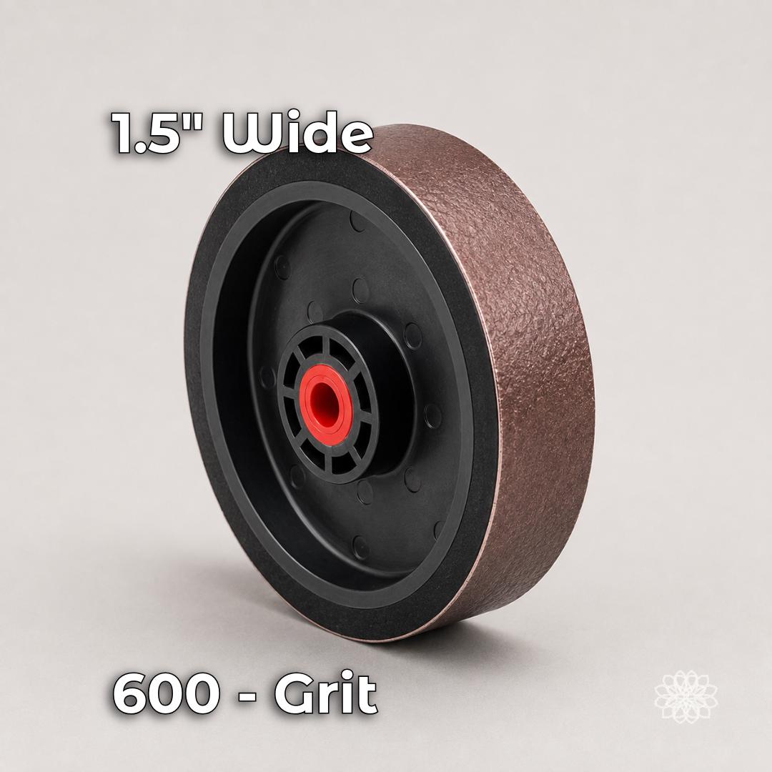 Six-inch by 1.5-inch brown soft resin diamond polishing wheel in 600 grit with a flexible black hub and red center bushing. Intended for smoothing cabochons and removing the scratches left by coarse grinding and 280-grit sanding stages.