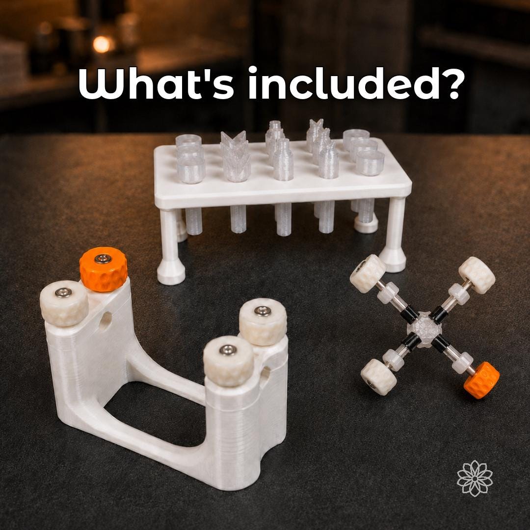 Complete Aetherium Gem Cutting Kit arranged on a dark workshop bench, including the white Gem Xfer transfer and cure station, clear Gem Axis stone alignment jig, white dop stick stand, and fifteen transparent polycarbonate dop sticks. The coordinated lapidary tool system uses white, clear, black, orange, and metal components.