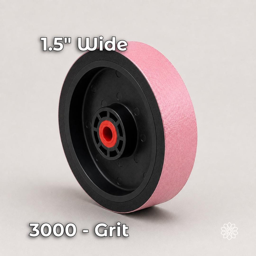 Six-inch by 1.5-inch pink soft resin diamond polishing wheel in 3000 grit with a flexible black hub and red arbor insert. Used for fine pre-polishing and high-grit surface refinement on cabochons before any material-specific final polish.