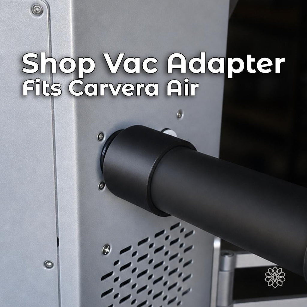 Makera Carvera Air shop-vac adapter with black 3D-printed construction, installed between the desktop CNC machine's rear dust port and a vacuum hose for external chip and dust collection.
