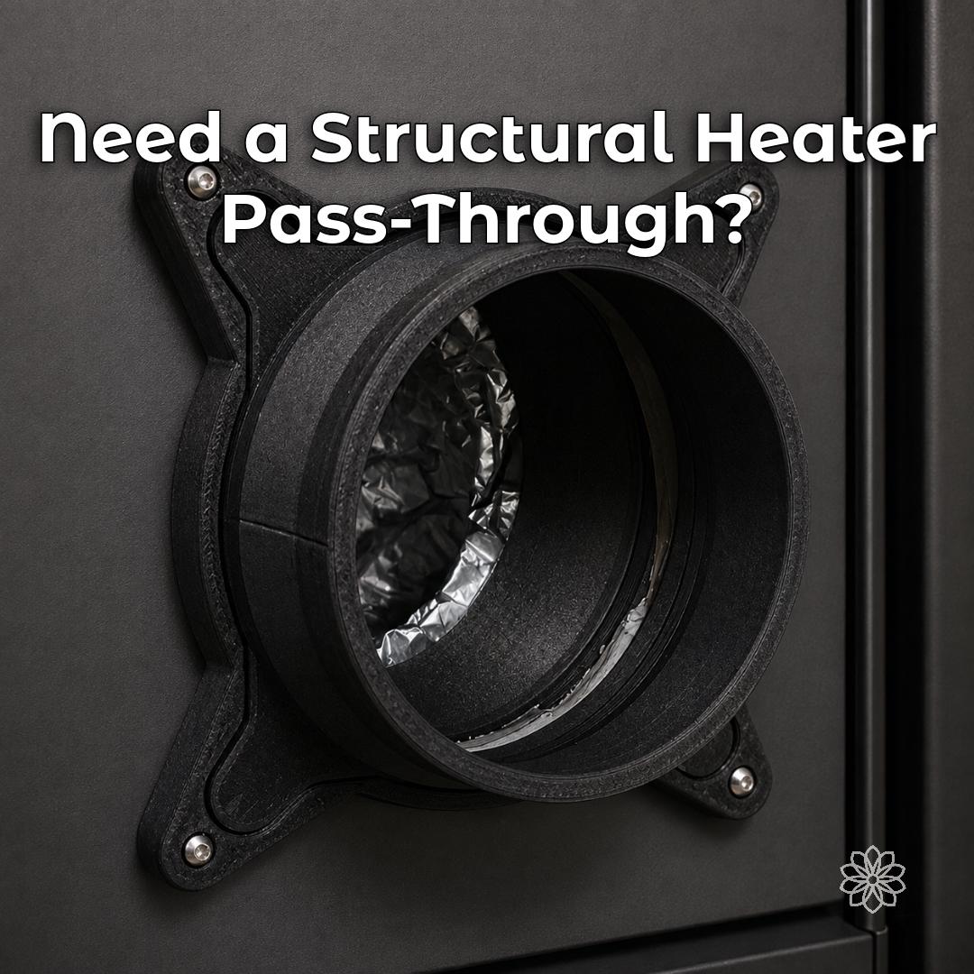 Black Vent Link structural heater pass-through mounted through a rigid wall panel, showing the open duct interface used to route warm air through campers, trailers, workshops, and enclosures.
