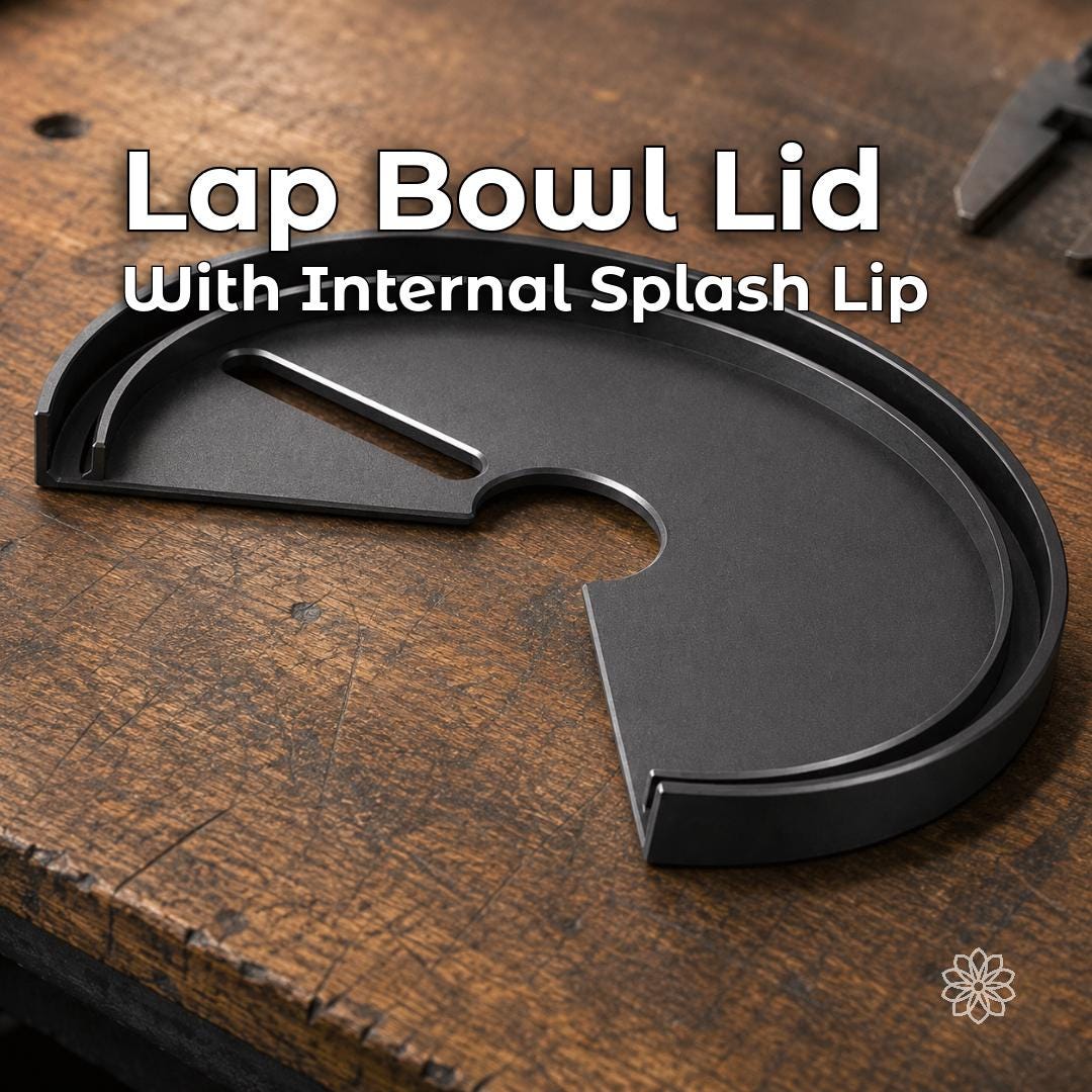 Black lap bowl lid for a VEVOR faceting machine shown on a wooden workbench. The removable cover includes an internal raised splash lip designed to intercept water, slurry, and swarf that would otherwise escape from the exposed area of the lap bowl during wet cutting.