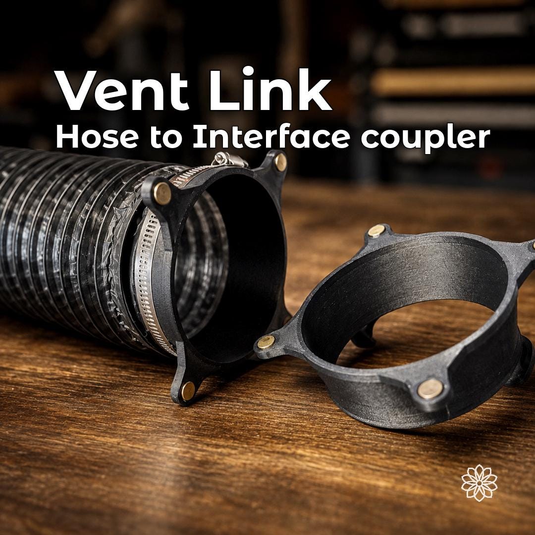 Vent Link magnetic hose couplers on a wood workbench, with one attached to 4-inch flexible heater duct by a metal clamp for quick connection to the structural wall interface.