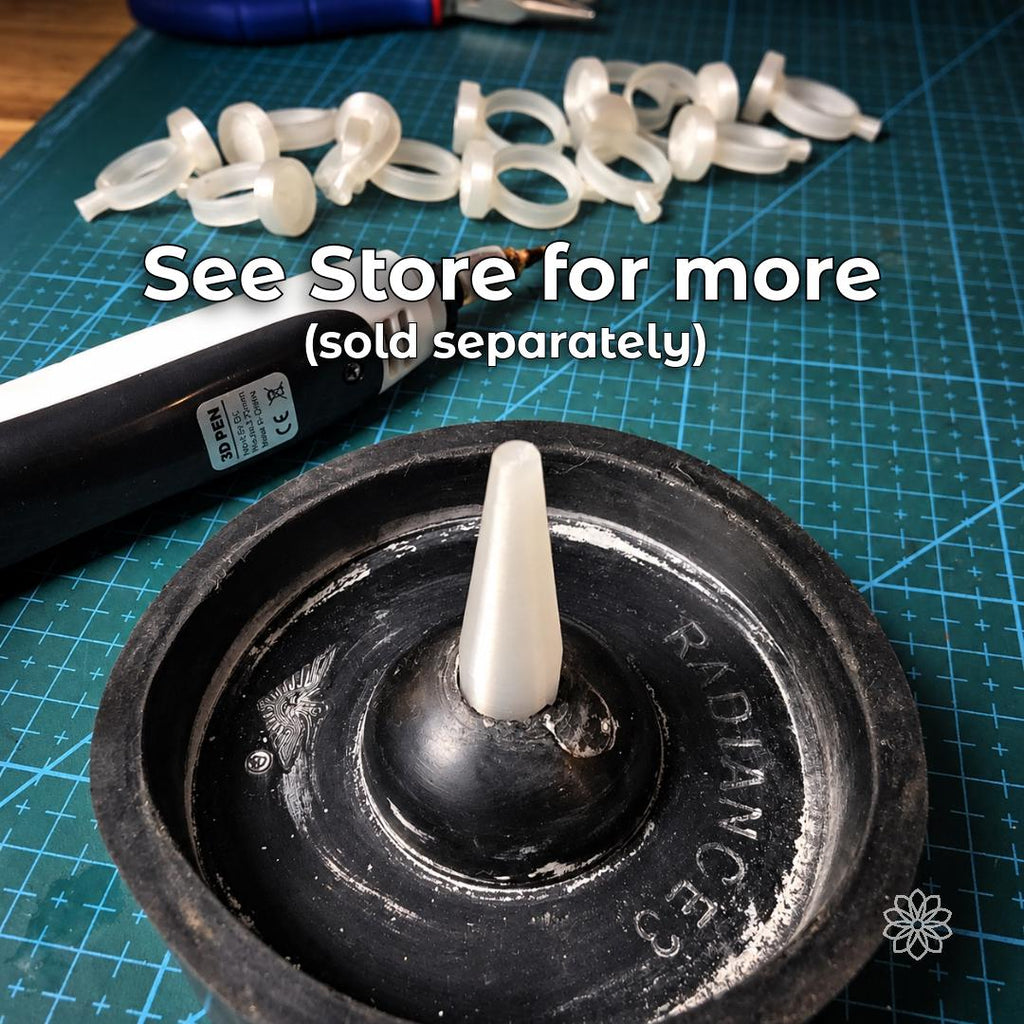 Jewelry wax carving setup with a wax ring blank, carving pen, and multiple ring forms on a jeweler’s work surface. Image directs makers toward additional wax carving, jewelry making, casting, and bench supplies available separately from Aetherium.