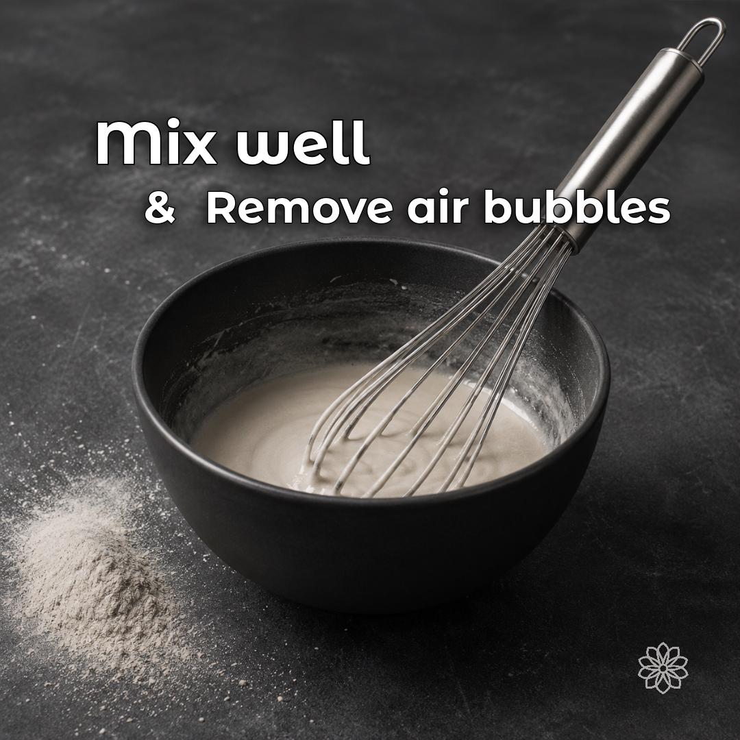 Jewelry investment powder being mixed for lost wax casting, with emphasis on reducing trapped air bubbles before pouring. Thorough mixing and proper vacuuming help prevent casting defects such as metal nodules, rough surface texture, and poor detail in finished rings and jewelry.