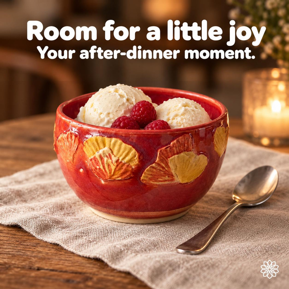 Small red botanical ceramic bowl holding vanilla ice cream and raspberries beside a teaspoon on linen. Text: Room for a little joy. Your after-dinner moment.